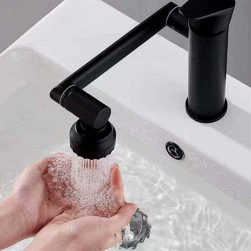 Black 1080-degree rotating faucet aerator installed on a bathroom sink, demonstrating its multi-angle adjustability. The image includes a motion effect with green arrows, showing the aerator’s ability to rotate for flexible water direction. Water is flowing from the extended nozzle, highlighting its practical use for washing and cleaning. A modern and versatile faucet upgrade for kitchens bathroom 